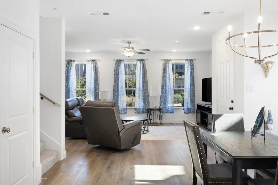 Open concept living, dining, and kitchen with the staircase at 4335 Fall Blossom Dr