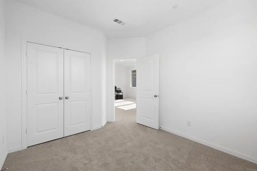 Secondary bedroom with closet doors opening toward the office at 4335 Fall Blossom Dr
