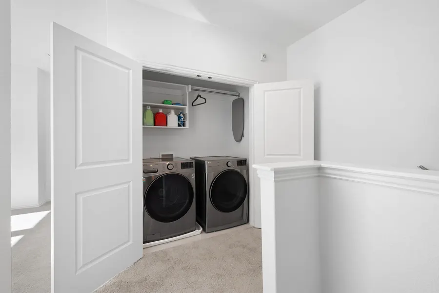Laundry closet with a stacked washer and dryer at 4335 Fall Blossom Dr