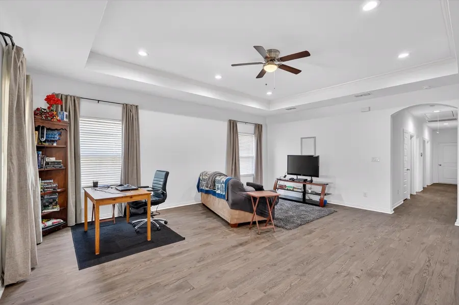Living room with a tray ceiling and ceiling fan at 4552 Corregidor St