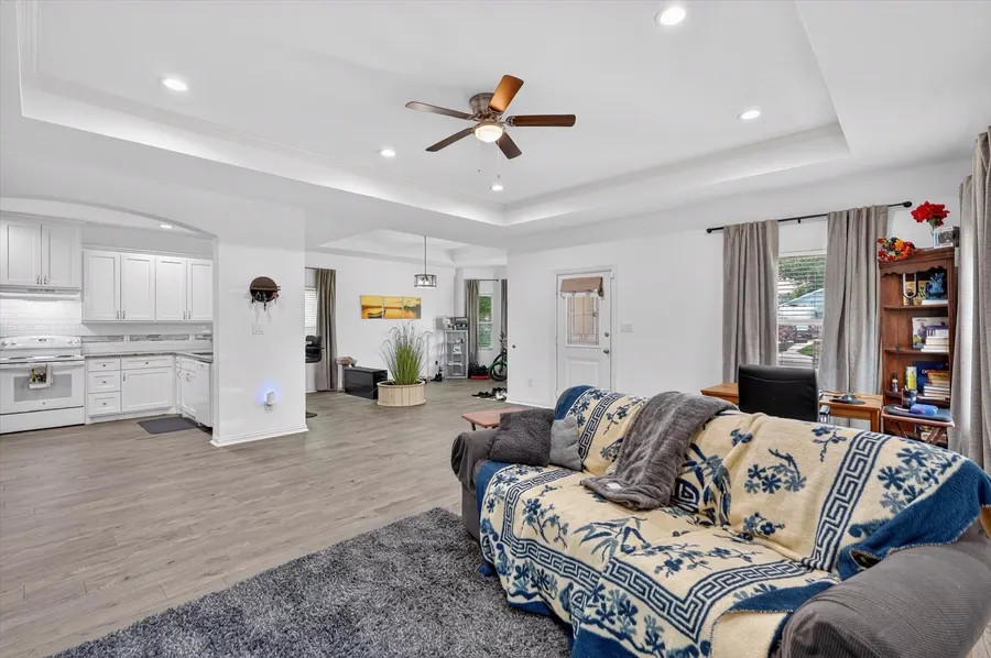 Living room open to the kitchen with a tray ceiling at 4552 Corregidor St