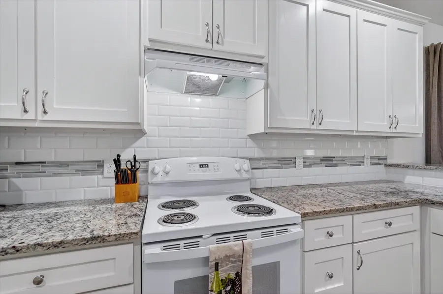 Kitchen with a stainless refrigerator and white cabinets at 4552 Corregidor St