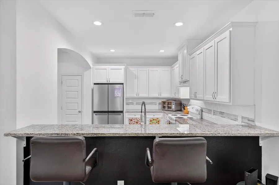Kitchen bar seating with granite counters at 4552 Corregidor St