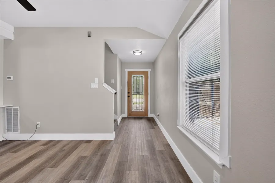 Entry hall with wood look flooring looking back toward the leaded glass front door at 716 River Hill Ln