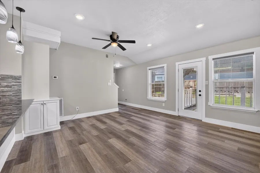 Dining space with pendant lighting, base cabinets, and a door to the back patio at 716 River Hill Ln