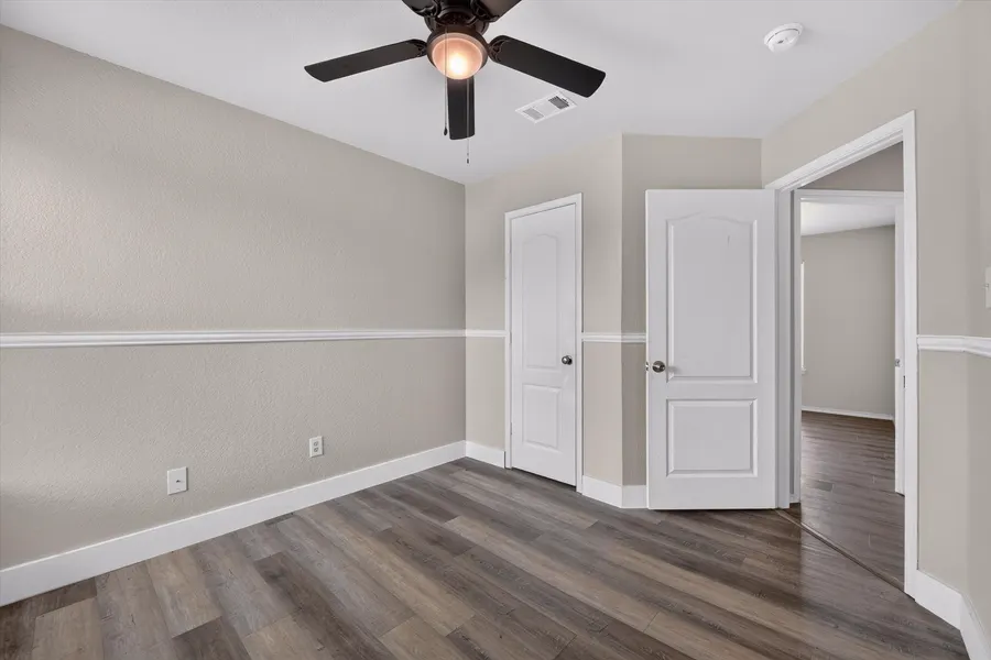 Bedroom with a ceiling fan and doors to the closet and hall at 716 River Hill Ln
