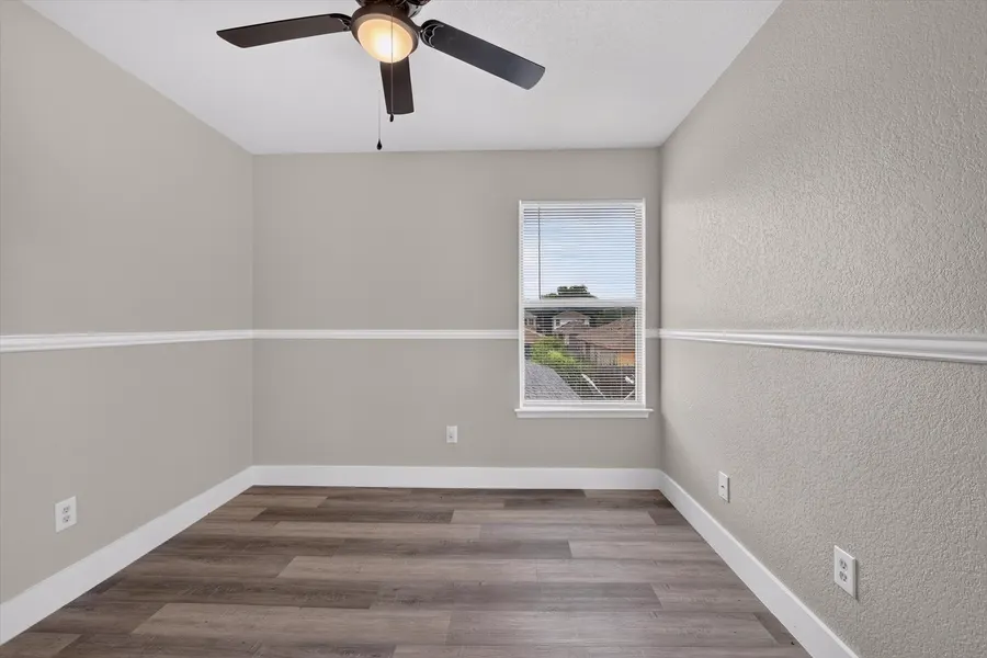 Bedroom with chair rail trim and a window over the rooftops at 716 River Hill Ln