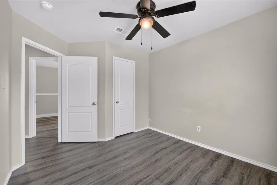 Bedroom with a closet door and an open doorway to the hall at 716 River Hill Ln