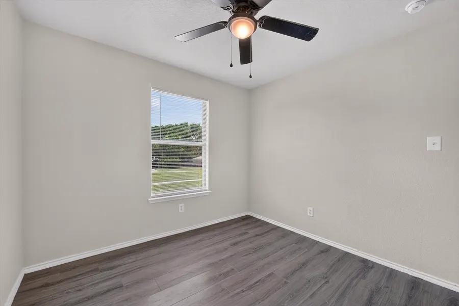Bedroom with a ceiling fan and a window over the front yard at 716 River Hill Ln