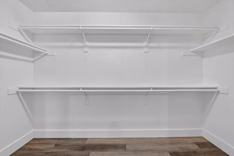 Walk in closet with double hanging rods and shelving at 716 River Hill Ln