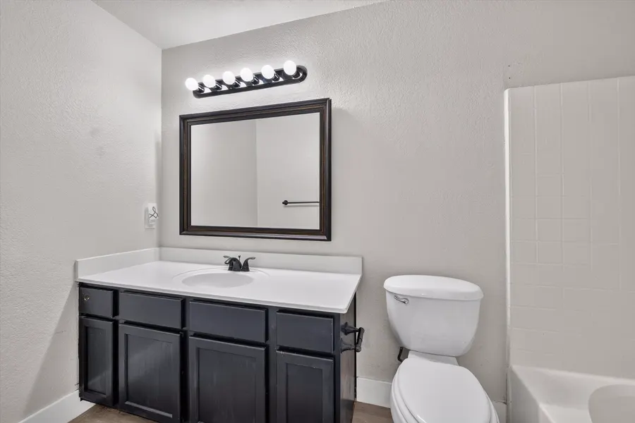 Full bath with a framed mirror, vanity, and tub shower combination at 716 River Hill Ln