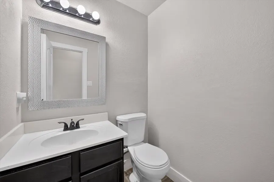Half bath with a vanity and framed mirror at 716 River Hill Ln