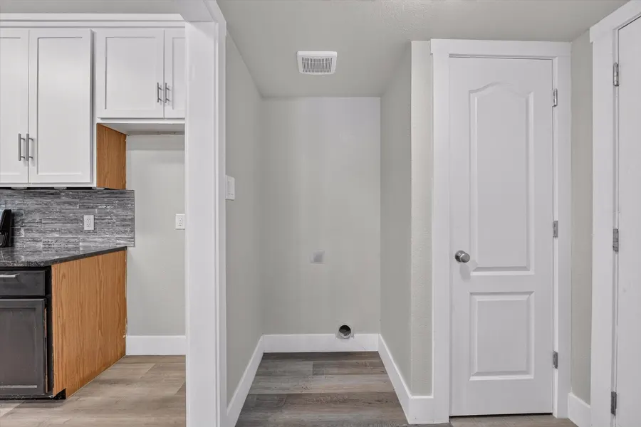 Laundry space with a utility closet beside the kitchen at 716 River Hill Ln