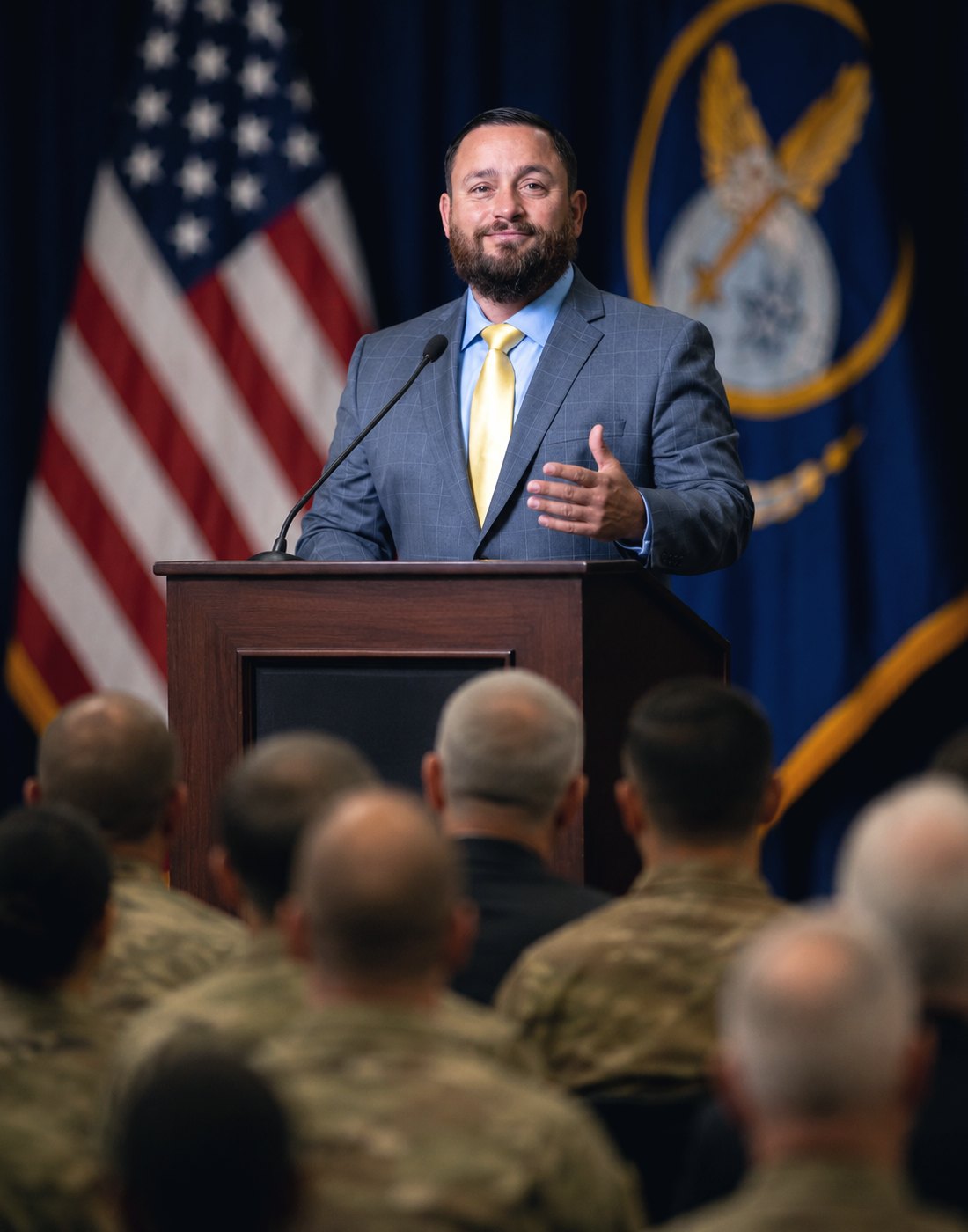 Mike Ritrovato speaking at a podium to a military audience